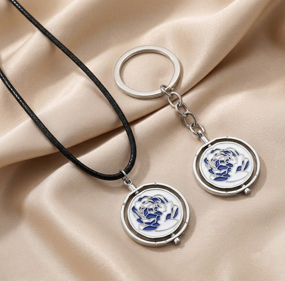 Interactive rotating spinner pendant necklace and keychain in pink and blue