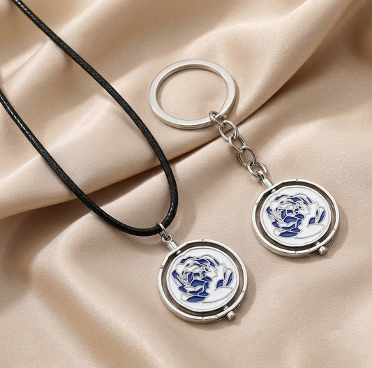 Interactive rotating spinner pendant necklace and keychain in pink and blue