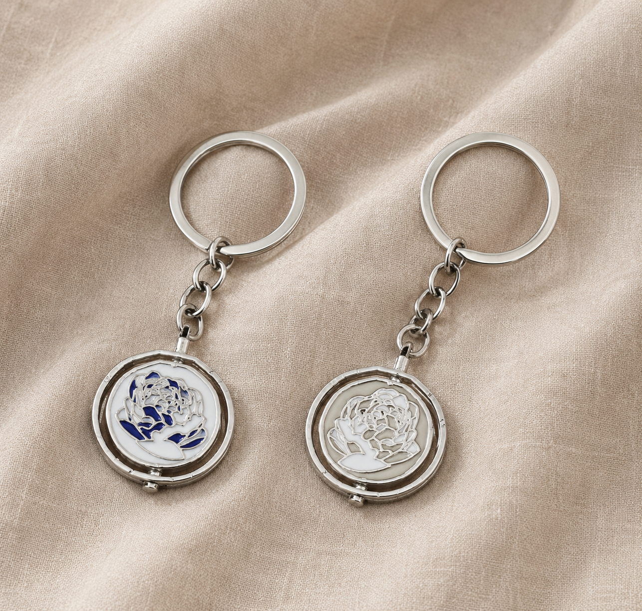 Interactive rotating spinner pendant necklace and keychain in pink and blue