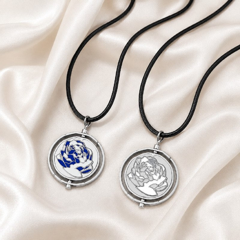 Interactive rotating spinner pendant necklace and keychain in pink and blue